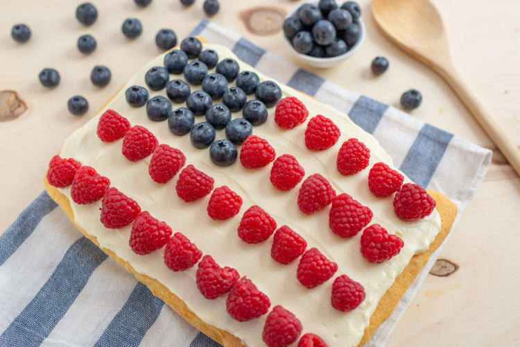 A rectangular cake with fruit arranged like a U.S. flag