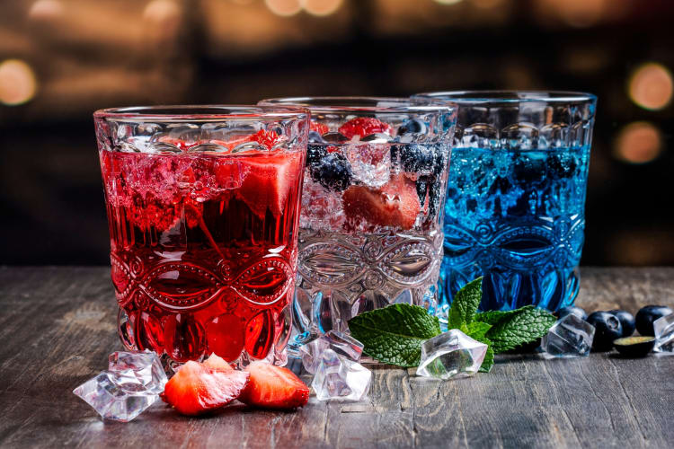 Red, clear and blue drinks with berries