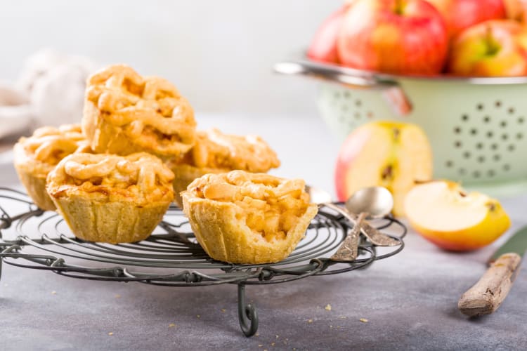 Mini apple pies next to apples