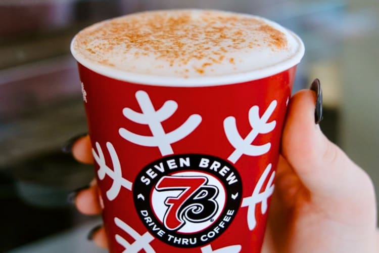 A red holiday coffee cup with a drink