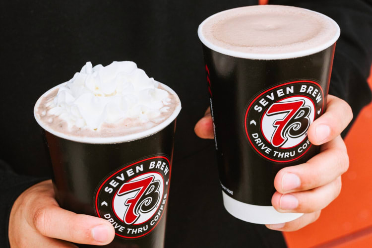 Two cups of hot cocoa, one with whipped cream