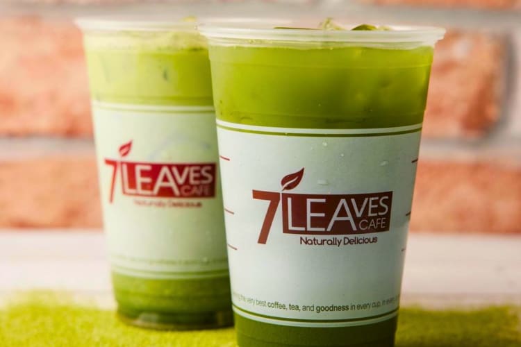 Two green iced tea drinks in plastic cups