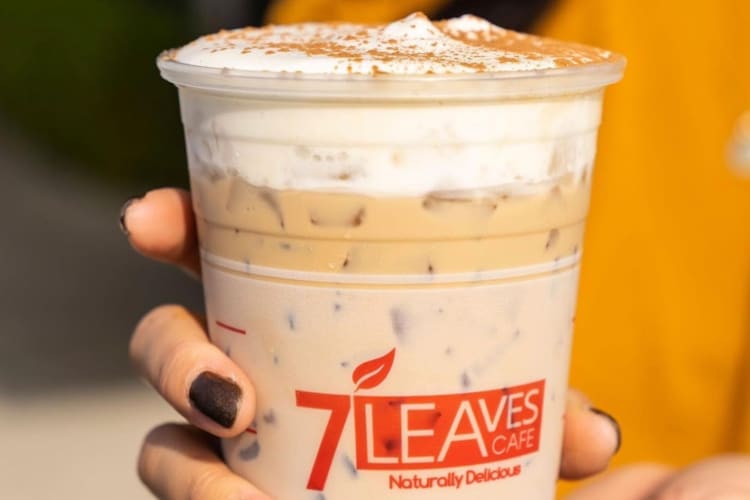 A milk tea drink with whipped cream on top