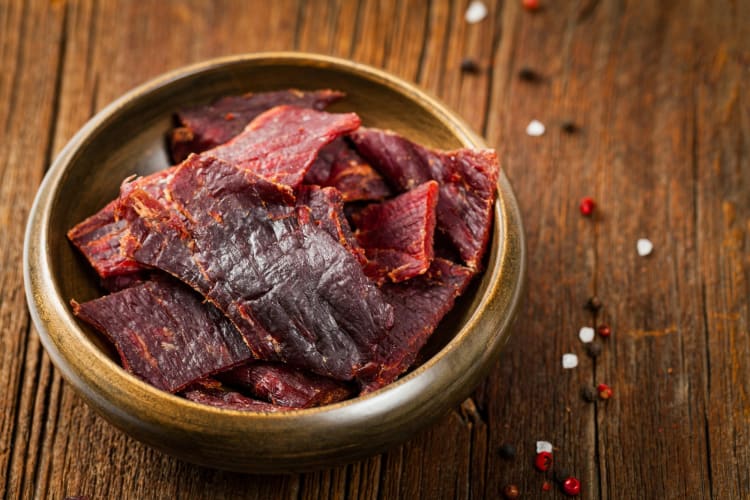 Beef jerky in a wooden bowl.