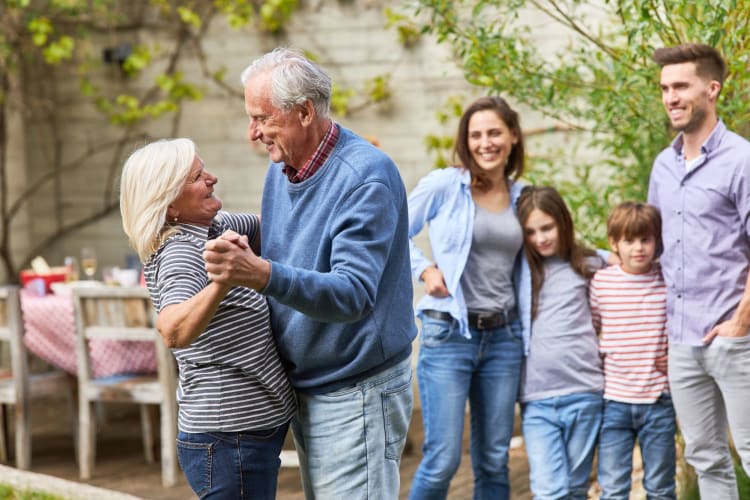 A senior couple dancing happily together.