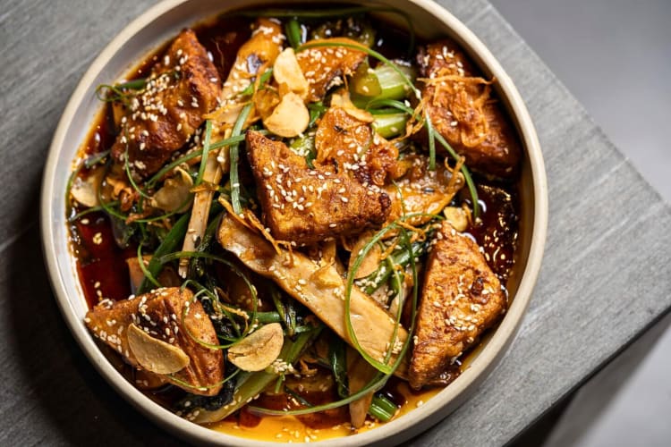 Aerial shot of a tofu and king oyster mushroom dish from ARTIFACT at Mingei