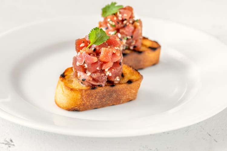 Two portions of wagyu tartare on pieces of bread