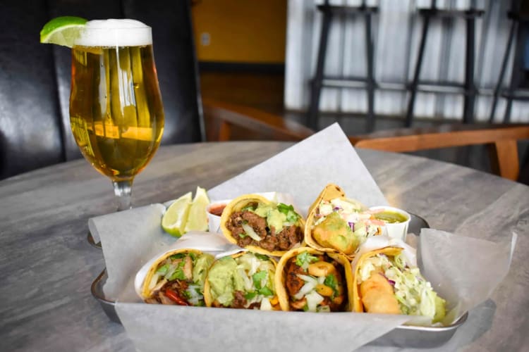 Tacos and a glass of beer on a table