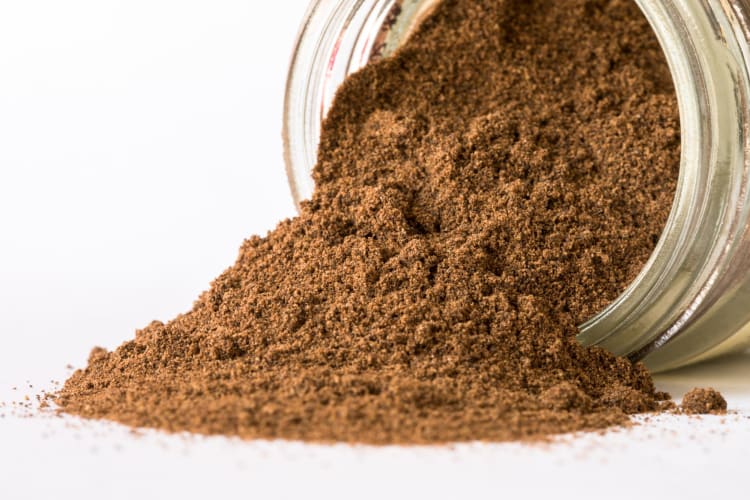 Jar of overturned allspice pouring out