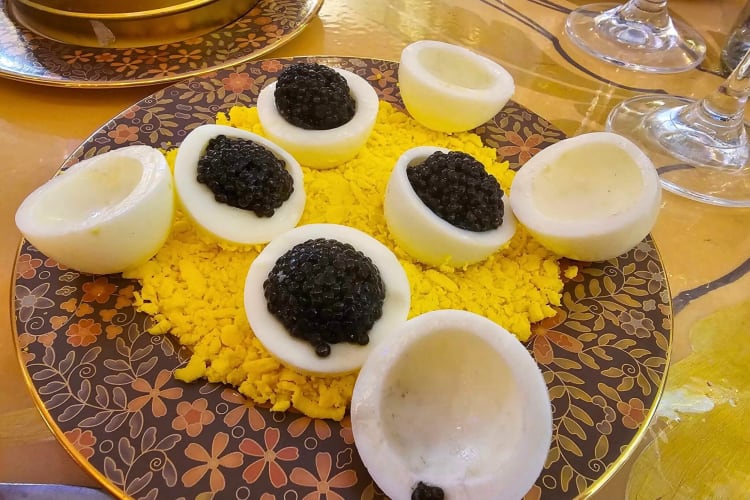 Four servings of caviar in egg white halves