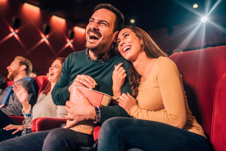 A couple watching a movie in the theater