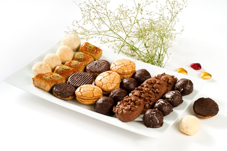 Variety of cookies on a white serving tray