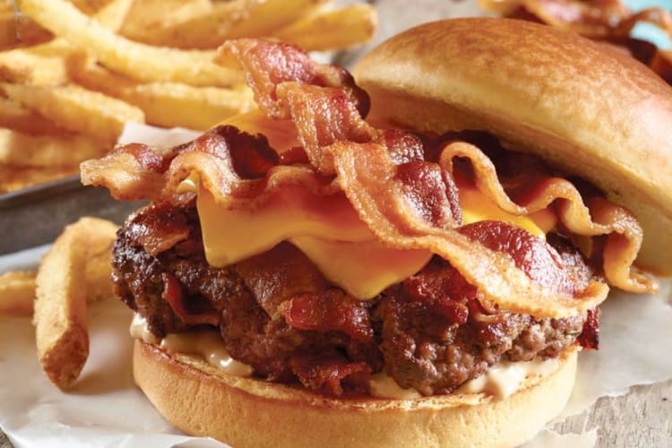 A cheeseburger with lots of bacon