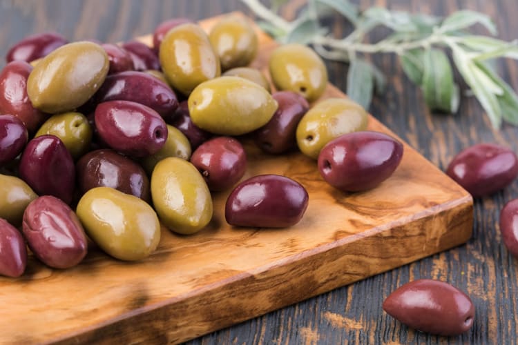 A board with different types of olives