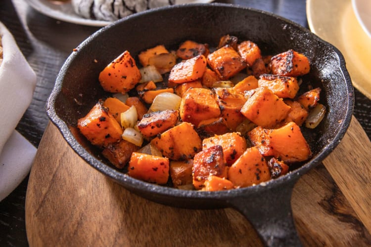 Roasting sweet potatoes in a pan.