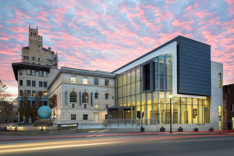 A museum building under a pink sunset sky