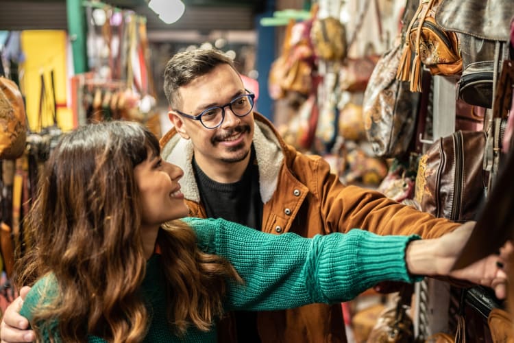 A couple looking at clothes in a thrift store