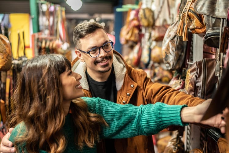 A couple looking at clothes in a thrift store