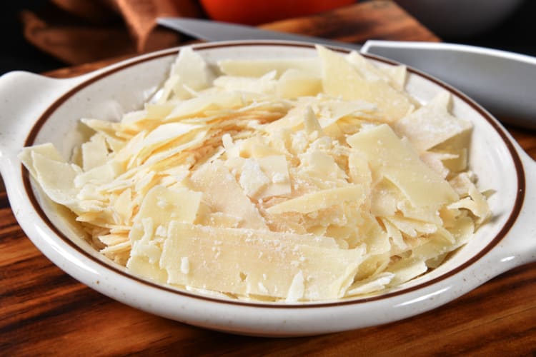 A bowl of grated Asiago cheese