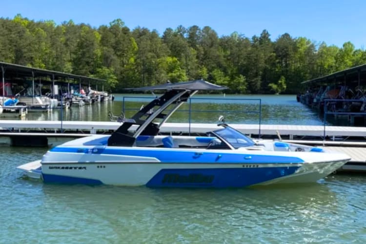 A white and blue boat is moored on the water