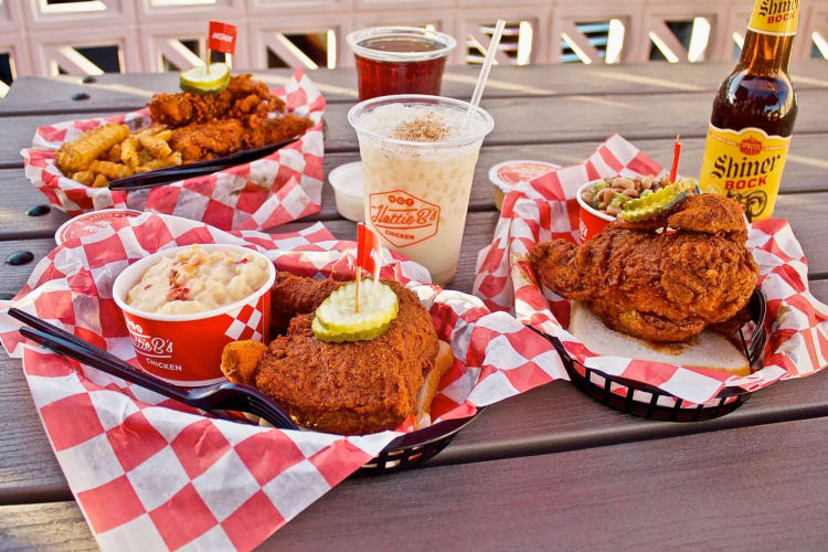 Hattie B's hot chicken dishes, drinks and sides on a table