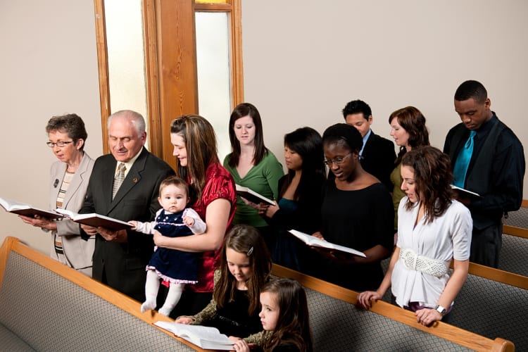 13 people reading from a book at a church service