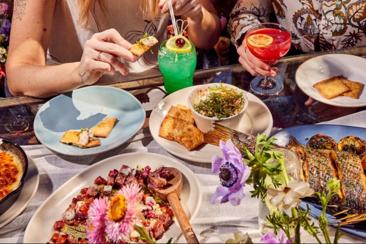 Various dishes and cocktails on a table