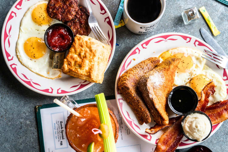 Breakfast dishes and a bloody mary on a table