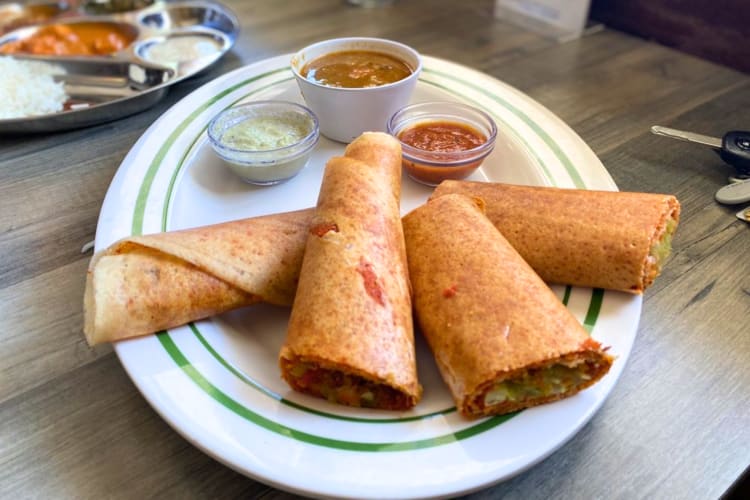 Stuffed dosa with various spicy dips.  