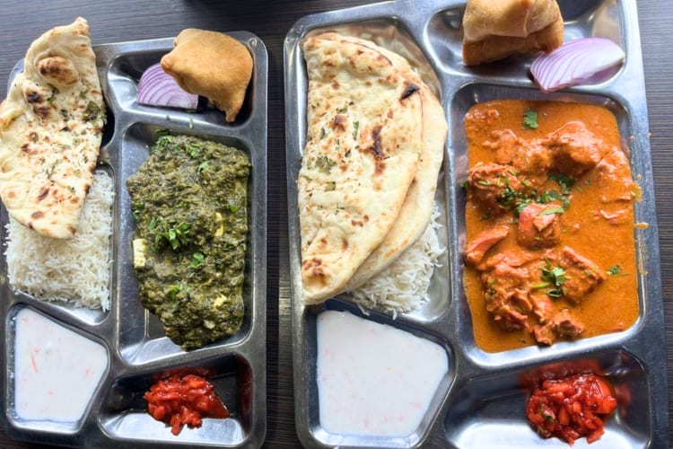 Chicken Tikka Masala, Garlic Naan, Vegetable simosa and butter chicken is available at this Indian restaurant in Boston. 