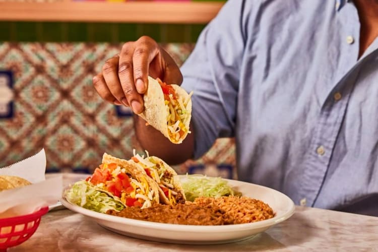 Crispy Tacos - hand-formed corn tortillas filled with seasoned ground sirloin, cheese, lettuce and tomatoes.