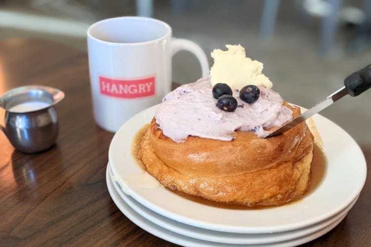 Try this freshly backed roll covered in maple syrup, whipped cream and blueberries at this breakfast spot in Minneapolis. 