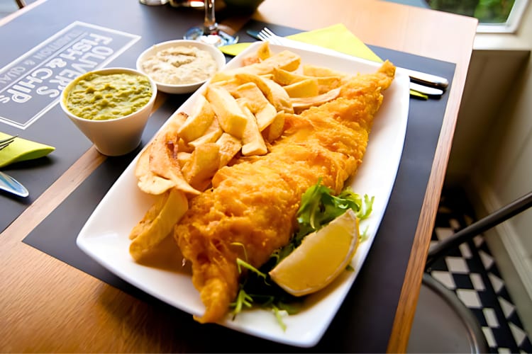 Authentic London fish and chips with mushy peas and tartar sauce on the side.