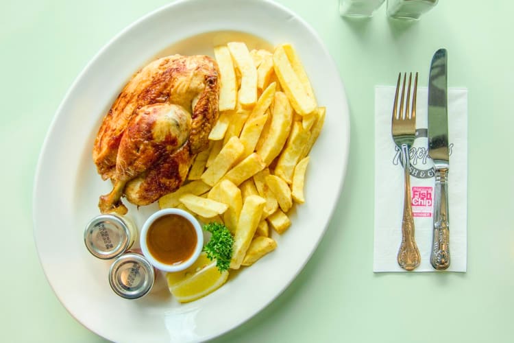 Half a grilled chicken along with classic London style chips