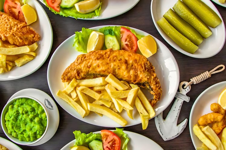 A variety of London fish & chip meals including fried cod and chips.
