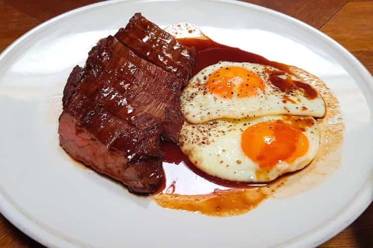 Try perfectly cooked steak with runny fried eggs on the side at this romantic restaurant in London. 