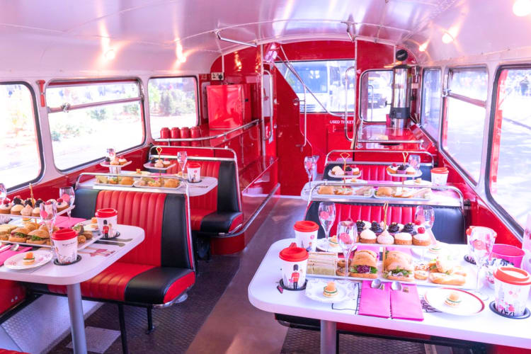 Have a very pink themed tea and cakes on a double decker bus for a team building activity in London. 