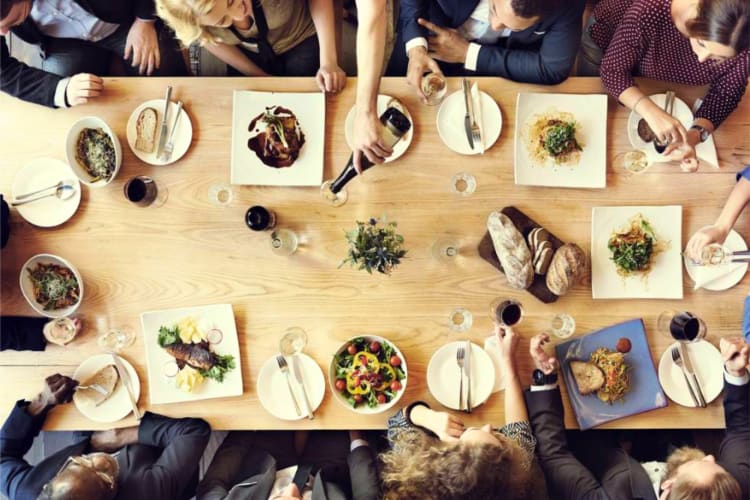 A group of collegues enjoying a nice meal for a team building activity in London. 