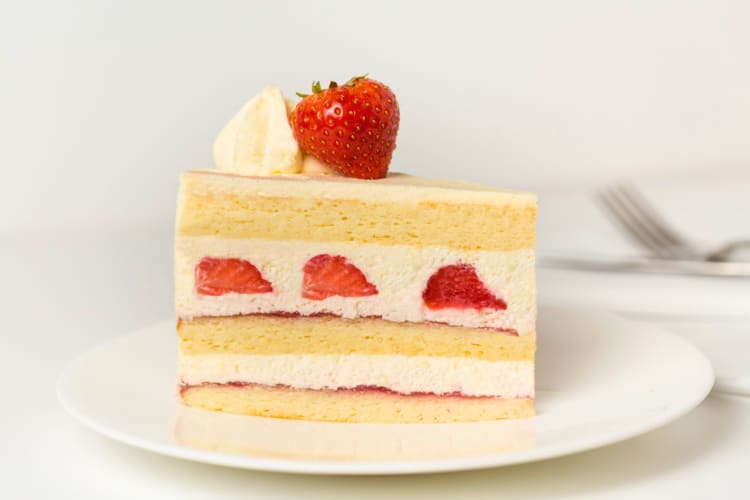 A slice of strawberry shortcake with fresh strawberries on top is an option for dessert in London. 