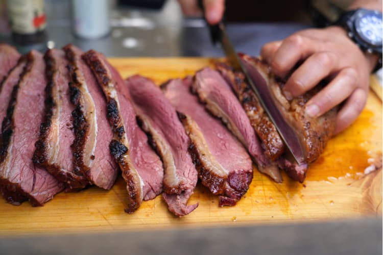 Cutting up a perfectly cooked brisket after it has reached the ideal brisket internal temp. 
