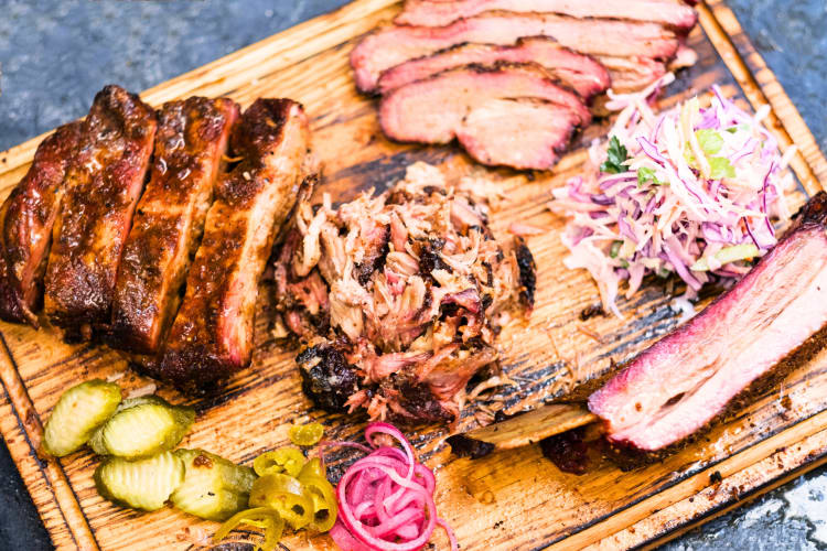 Cooked brisket with pickles, red onions and coleslaw. 