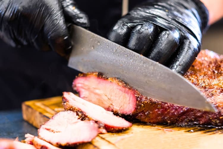 Cutting hot and fast cooked brisket. 