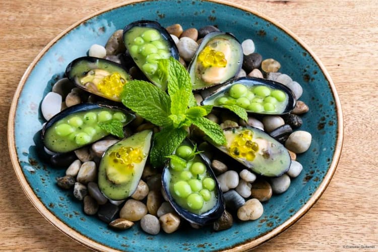 At this Michelin star restaurant in Barcelona, try fresh oysters with beans. 