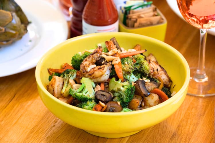 Try the Salmon Wok Out Bowl that's also stuffed with veggies and prawns. 