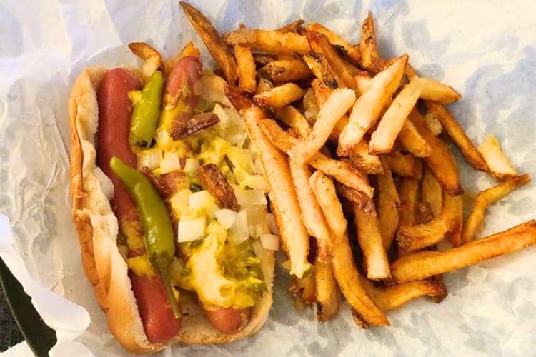 A double hot dog topped with onions and sauce can be found at this fast food Chicago joint. 