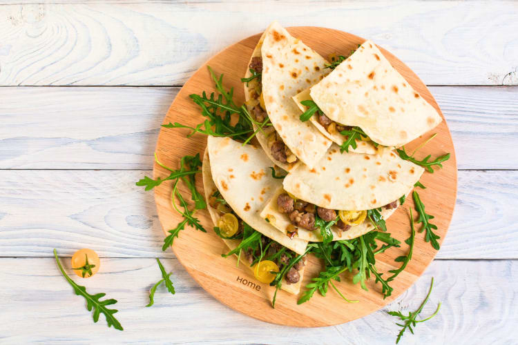 Piadina stuffed with beef and tomatoes is a much loved Milan food. 