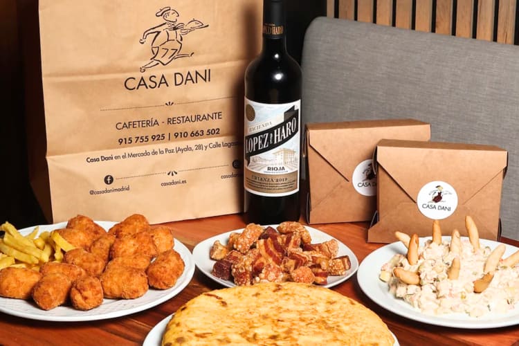 A variety of meals made by this Madrid restaurant including pork belly, an omelette and chicken fingers and mash potato. ,  