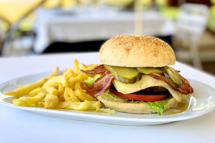 Order a classic American cheese and bacon burger and fries at this unique Madrid restaurant. 