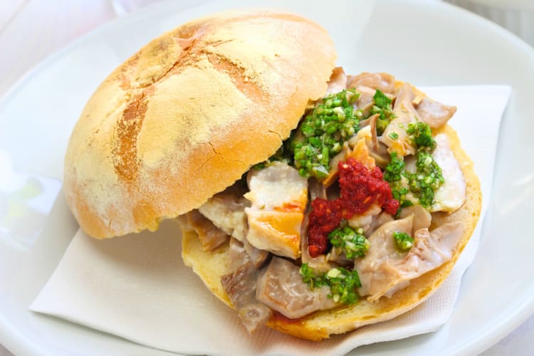 Lampredotto is a meat based sandwich topped with some pesto sauce. 