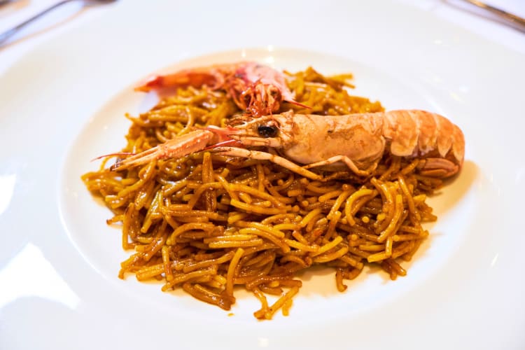 Fideuà is a Barcelona food that looks similar to paella though uses noodles rather than rice. 